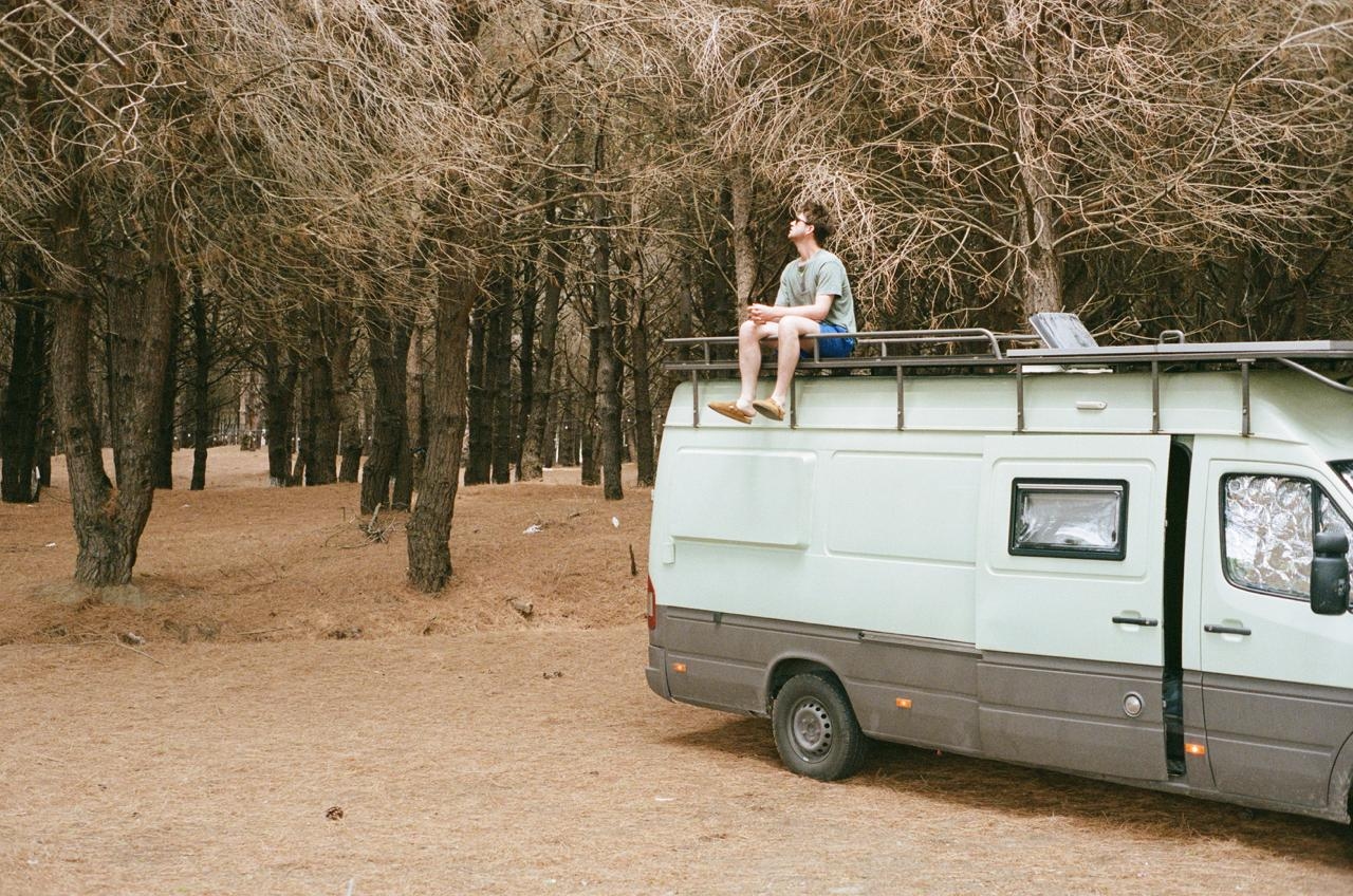 Discount image with a campervan in the woods